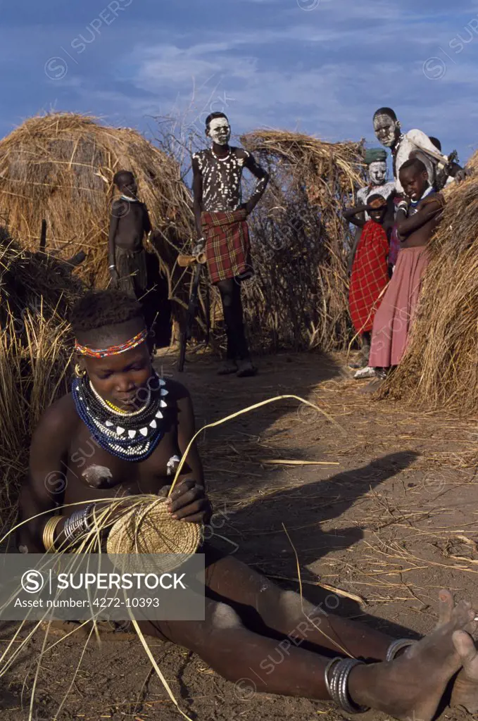 A Nyangatom girl weaves a grass basket. The Nyangatom or Bume are a Nilotic tribe of semi-nomadic pastoralists who live along the banks of the Omo River in south-western Ethiopia.