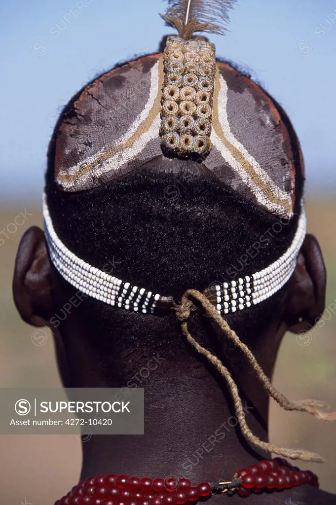 A Dassanech man shows off his distinctive clay hairdo.  The central pannel consists of tightly packed coils of sisal thread extracted from grain sacks that allow the scalp to breathe underneath the clay. Much the largest of the tribes in the Omo Valley numbering around 50,000, the Dassanech (also known as the Galeb, Changila or Merille) are Nilotic pastoralists and agriculturalists.