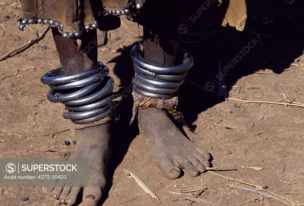 A young Dassanech girl wears heavy metal anklets beneath her beaded leather skirt.  Much the largest of the tribes in the Omo Valley numbering around 50,000, the Dassanech (also known as the Galeb, Changila or Merille) are Nilotic pastoralists and agriculturalists.