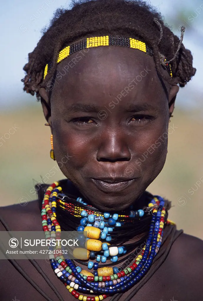 A young Dassanech girl wears a beautiful array of beaded necklaces.  Much the largest of the tribes in the Omo Valley numbering around 50,000, the Dassanech (also known as the Galeb, Changila or Merille) are Nilotic pastoralists and agriculturalists.