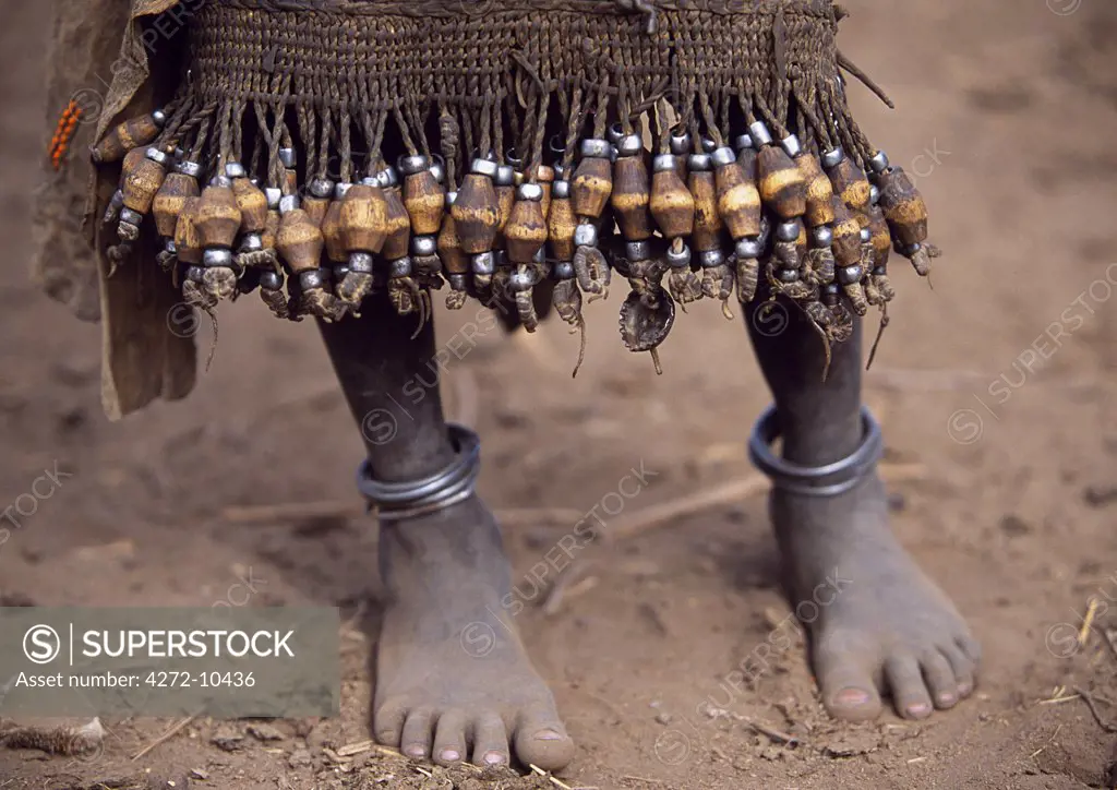 A young Dassanech girl wears a leather skirt with an elaborate fringe of wooden and metal tassles.  Much the largest of the tribes in the Omo Valley numbering around 50,000, the Dassanech (also known as the Galeb, Changila or Merille) are Nilotic pastoralists and agriculturalists.