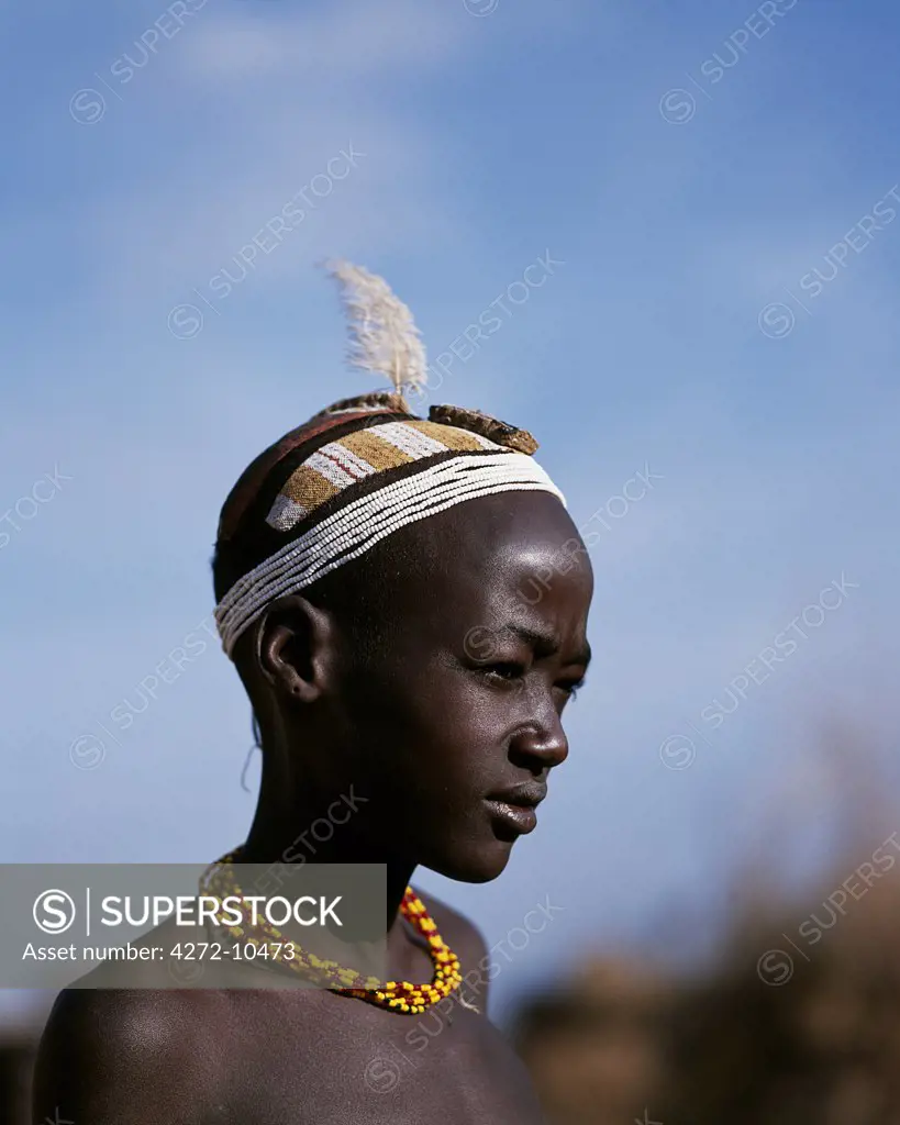 A young Dassanech boy with an elaborate clay hairdo and headband of beads at his village in the Omo Delta.  Much the largest of the tribes in the Omo Valley numbering around 50,000, the Dassanech (also known as the Galeb, Changila or Merille) and Nilotic pastoralists and agriculturalists.