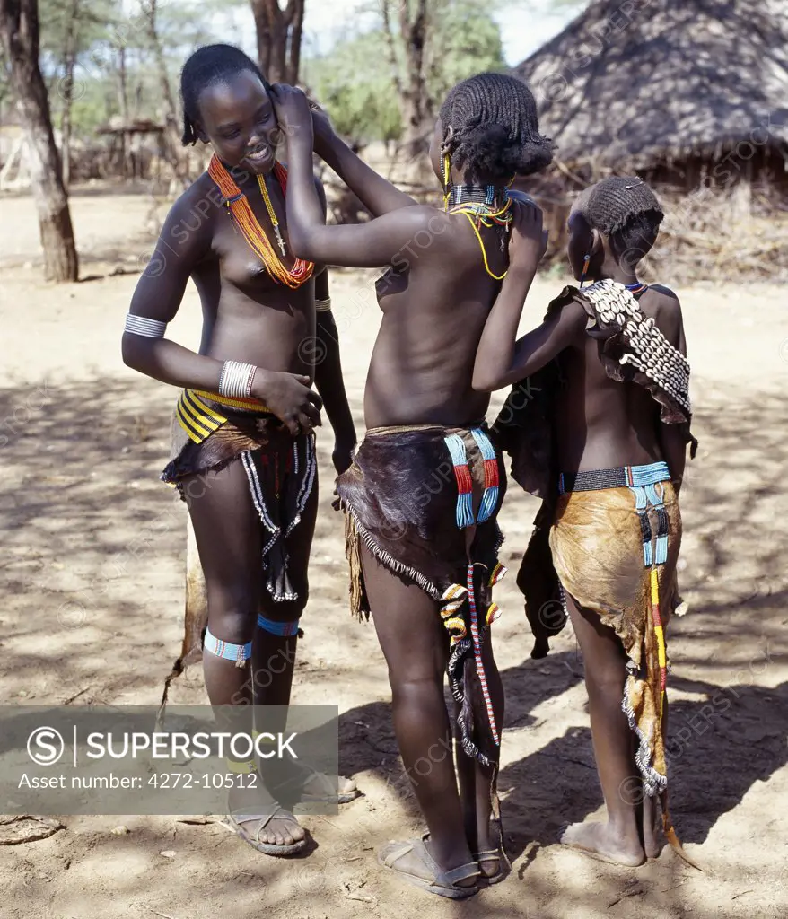 Girls of the Tsemay tribe of remote Southwest Ethiopia wear attractively decorated leather skirts and aprons, and braid their hair in a number of different eye-catching styles.The Tsemay are a small tribe neighbouring the more numerous Hamar people with whom they share a common language.