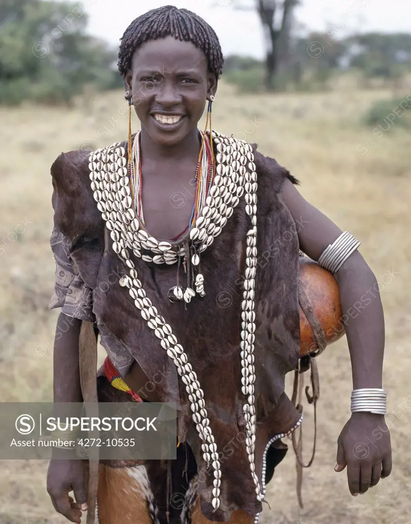 A woman of the Tsemay tribe of remote Southwest Ethiopia wears attractively decorated leather clothes. Her hair is braided and smeared with ochre.The Tsemay are a small tribe neighbouring the more numerous Hamar people with whom they share a common language.