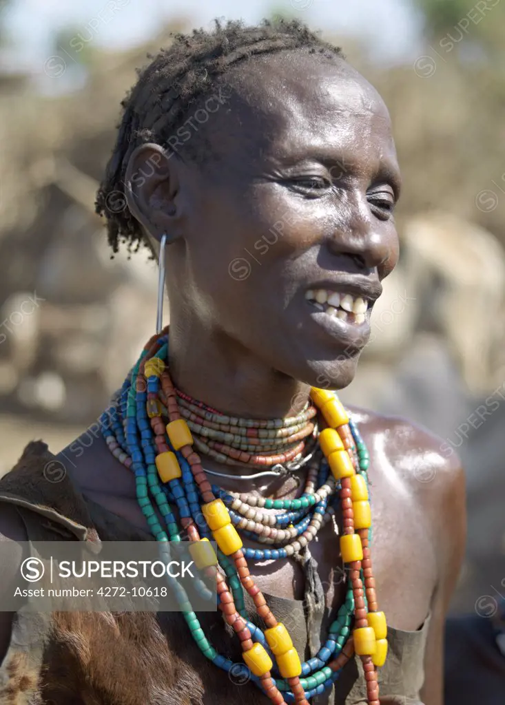 A Dassanech woman in jovial mood. The Dassanech speak a language of Eastern Cushitic origin. They live in the Omo Delta and they practice animal husbandry and fishing as well as agriculture.