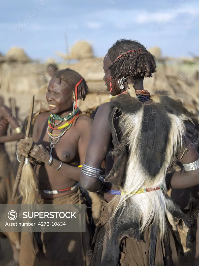 In the early morning, Dassanech women prepare to participate in a Dimi ceremony, an important initiation ceremony, which every male member of the tribe must undergo before their daughters are circumcised prior to marriage.  The Dassanech speak a language of Eastern Cushitic origin.