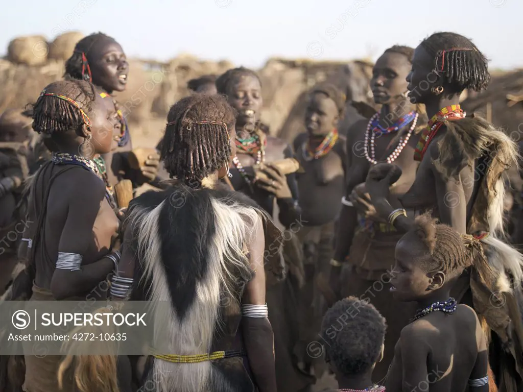 In the early morning, Dassanech women prepare to participate in a Dimi ceremony, an important initiation ceremony, which every male member of the tribe must undergo before their daughters are circumcised prior to marriage.  The Dassanech speak a language of Eastern Cushitic origin.