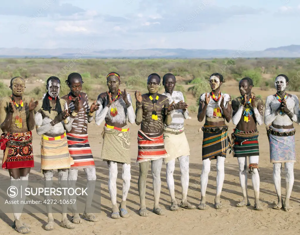 Karo men dance in line by jumping high in the air, legs straight. Even while dancing, they each keep hold of their wooden stools, which double as pillows at night. The Karo are a small tribe living in three main villages along the lower reaches of the Omo River in southwest Ethiopia.