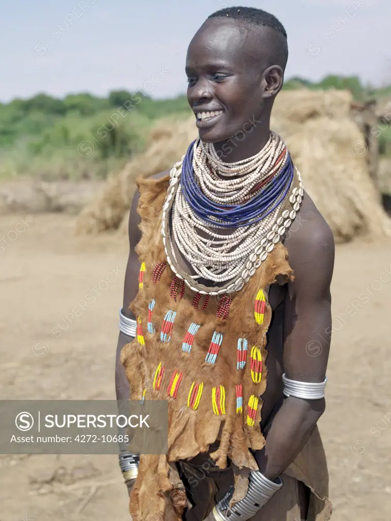 A Kwegu woman in an attractively decorated leather garment. The Kwegu are the smallest tribe living on the banks the Omo River in southwest Ethiopia.