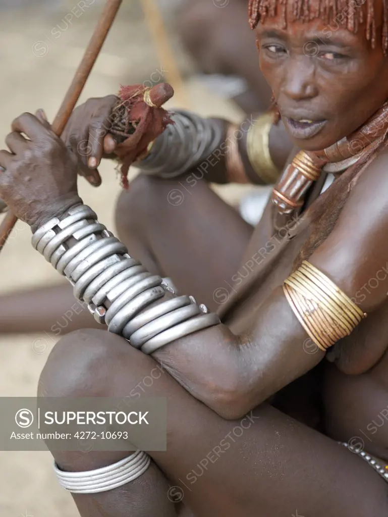 A Hamar woman at a Jumping of the Bull ceremony. The Hamar are semi nomadic pastoralists of Southwest Ethiopia whose women wear striking traditional dress and style their red ochred hair mop fashion.