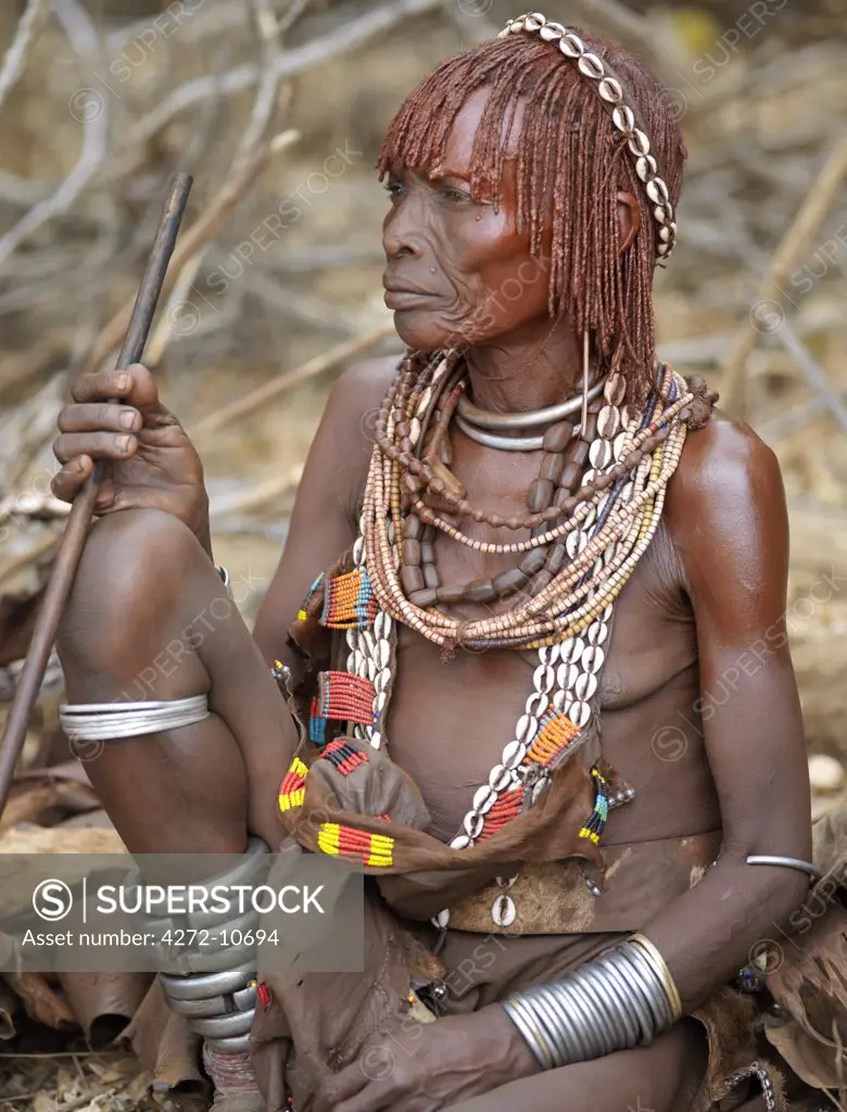 A Hamar woman at a Jumping of the Bull ceremony. The Hamar are semi nomadic pastoralists of Southwest Ethiopia whose women wear striking traditional dress and style their red ochred hair mop fashion.