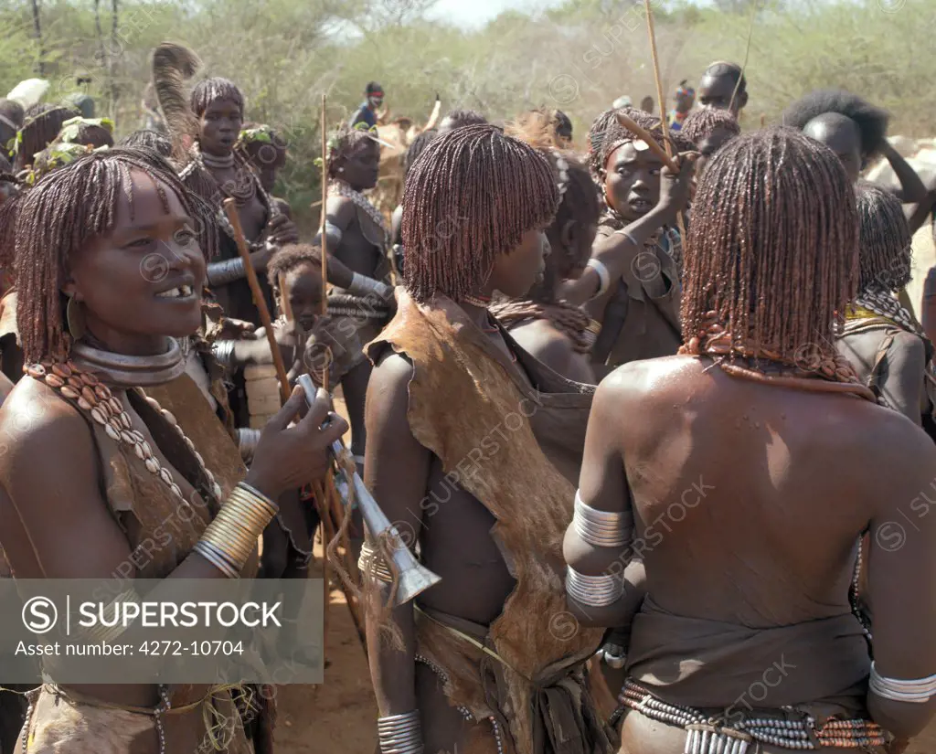 A group of Hamar women at a Jumping of the Bull ceremony. The Hamar are semi nomadic pastoralists of Southwest Ethiopia whose women wear striking traditional dress and style their red ochred hair mop fashion.