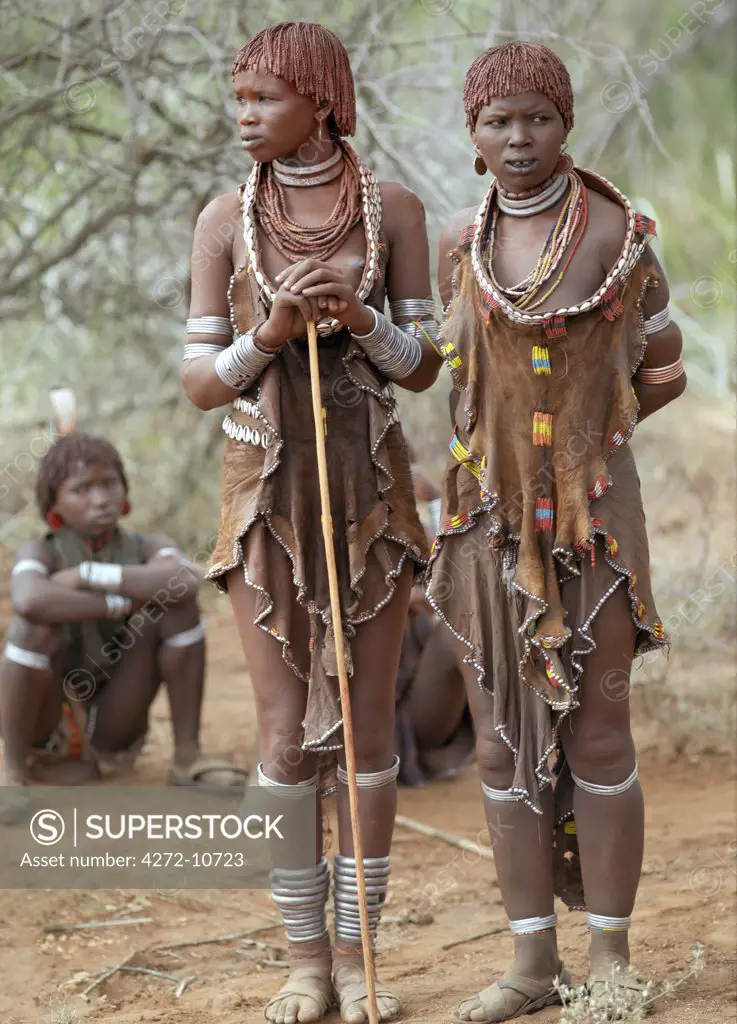 Hamar women attend a Jumping of the Bull ceremony.The Hamar are semi nomadic pastoralists of Southwest Ethiopia whose women wear striking traditional dress and style their red ochred hair mop fashion.