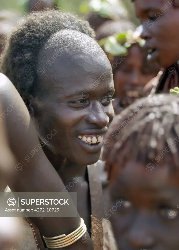All smiles after a young Hamar man, surrounded by his friends and relatives, has successfully completed his Jumping of the Bull ceremony. The semi nomadic Hamar of Southwest Ethiopia embrace an age grade system that includes several rites of passage for young men.