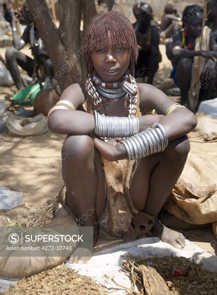 A Hamar woman at Turmi Market.The Hamar are semi nomadic pastoralists of Southwest Ethiopia whose women wear striking traditional dress and style their red ochred hair mop fashion.