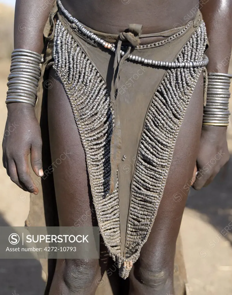The leather skirt of a Nyagatom girl richly decorated with metal beads. The Nyagatom are one of the largest tribes and arguably the most warlike people living along the Omo River in Southwest Ethiopia.
