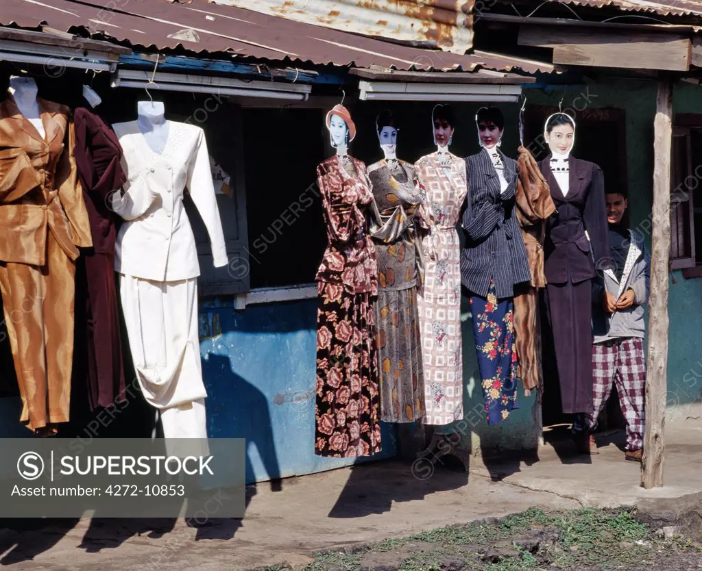 Unconventional tailors' dummies display ladies' dresses on the side of the road at Dese.