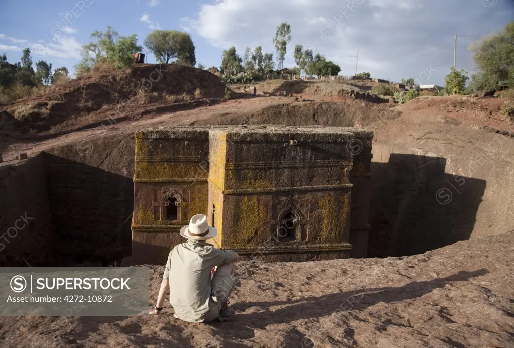 Ethiopia, Lalibela, Bet Giyorgis. A tourist gazes at the rock-hewn church of Bet Giyorgis. (MR)