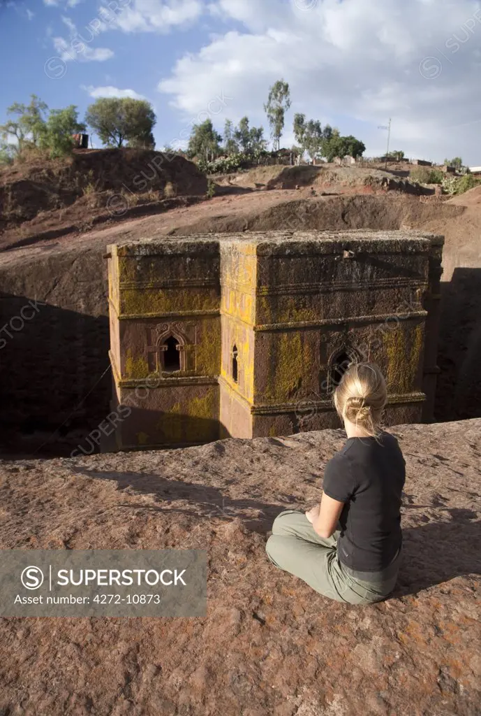 Ethiopia, Lalibela, Bet Giyorgis. A tourist gazes at the rock-hewn church of Bet Giyorgis. (MR)