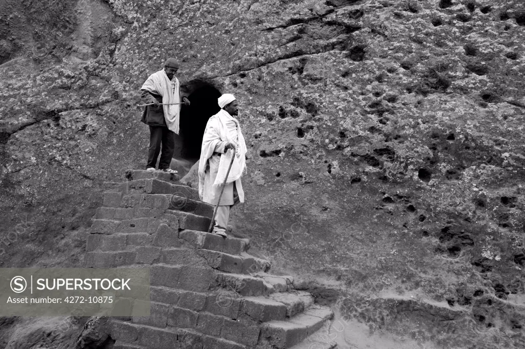 Ethiopia, Lalibela. A priest emerges from an ancient rock-hewn Church.