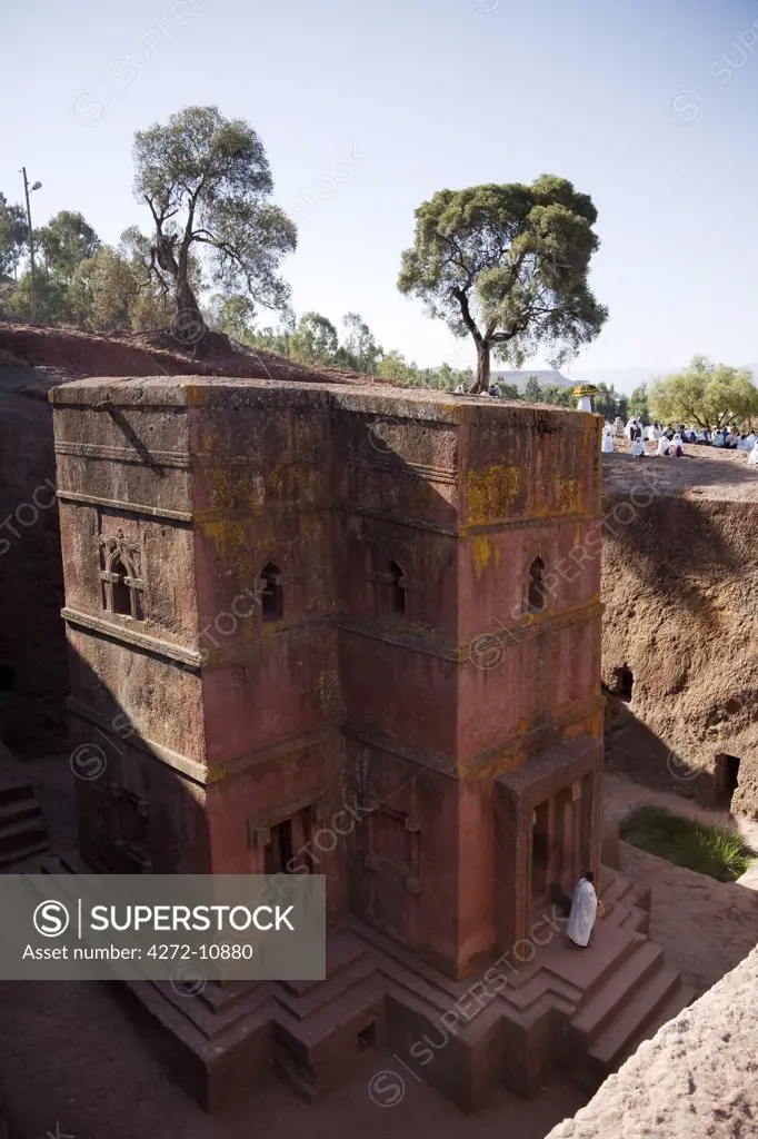 Ethiopia, Lalibela. A priest emerges from the ancient rock-hewn Church of Bet Giyorgis.