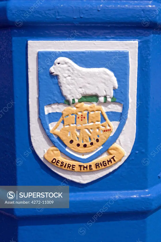 The Falkand Island coat of arms painted on Port Stanley bin.   Granted on September 29, 1948.   The ship represents the Desire, the vessel in which the British sea-captain, John Davis, is reputed to have discovered the Falkland Islands in 1592.   The motto Desire the Right also refers to the ship's name.   The ram represents sheep-farming, until recently the principal economic activity of the islands. The tussock grass shows the most notable native vegetation.