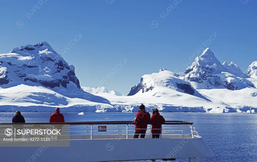 Antarctica, Antarctica Peninsula. Passengers on the stern of the MV Discovery and cruising along Graham Land and the Antarctic Peninsula. Antarctica