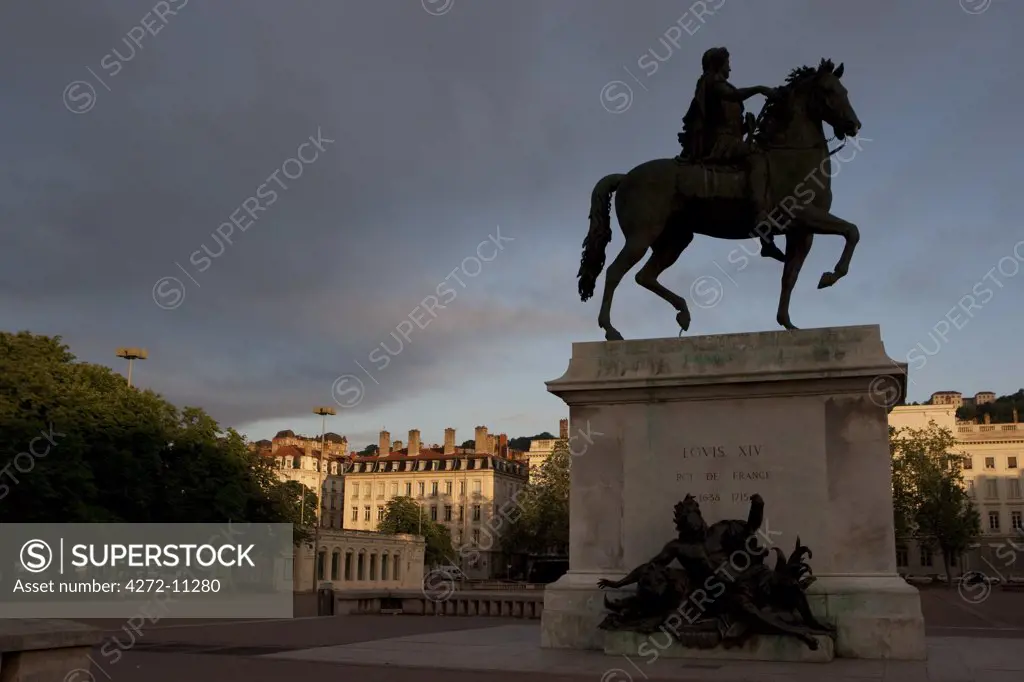 Lyon, France; Statue of Louis XIV and Basilique Notre Dame de Fourviere Place Bellecour Presqu ile