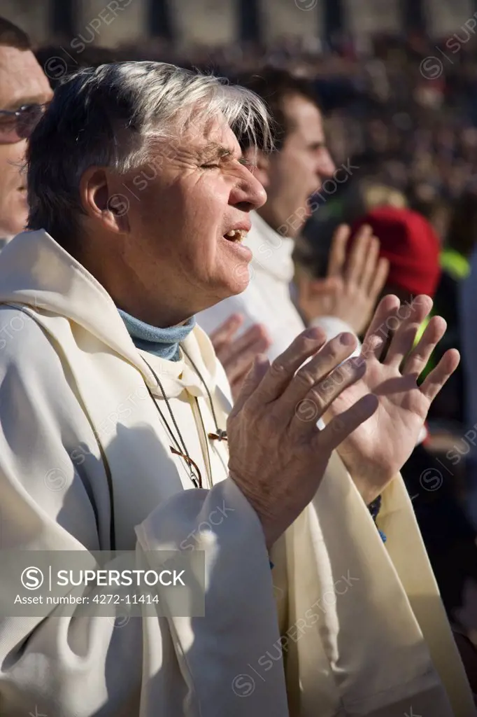 A priest in a mass in front of the Sanctuary of Our Lady of Lourdes, France