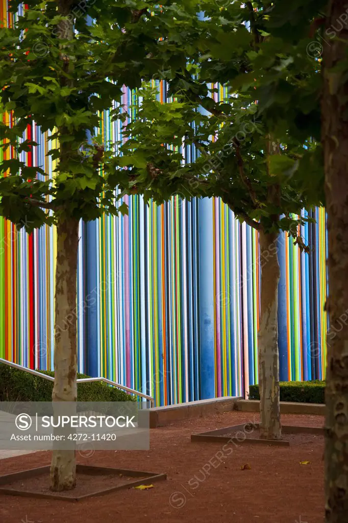 Contemporary art sculpture Tall tower Thin coloured stripes bar code pattern in La Defense, the main bussines district in Paris, France