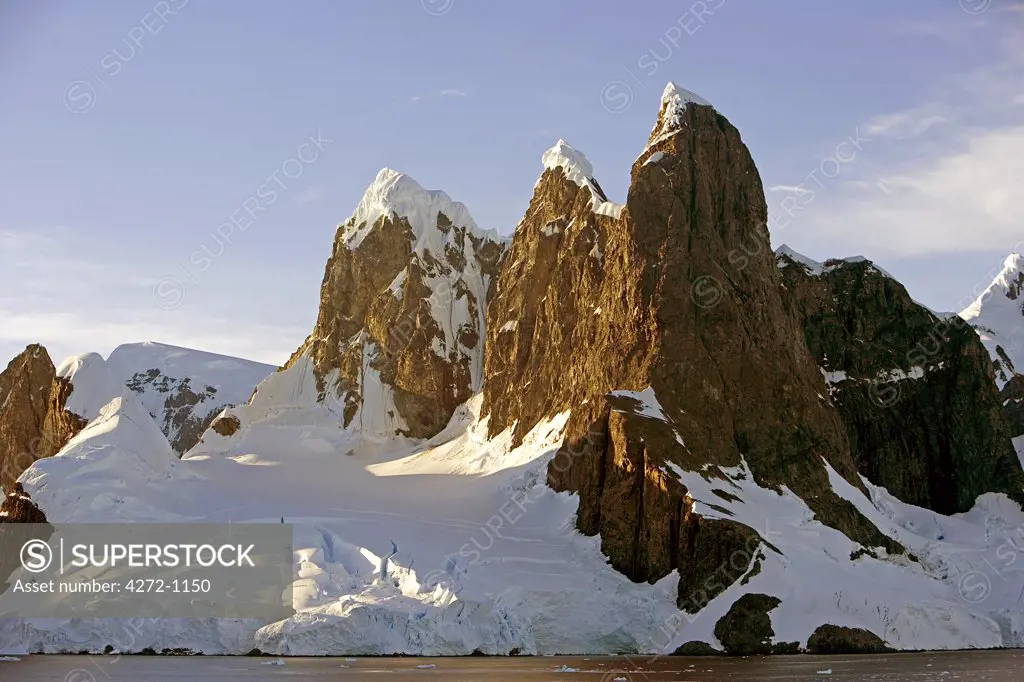 Antarctica, Booth Island, Lemaire Channel. At the northern end of Lemaire Channel is a pair of tall, rounded and often snow capped peaks known as Unas Tits. Known as Kodak Gap, this narrow waterway flows between the 3,000 foot peaks of Booth Island and the peninsula.
