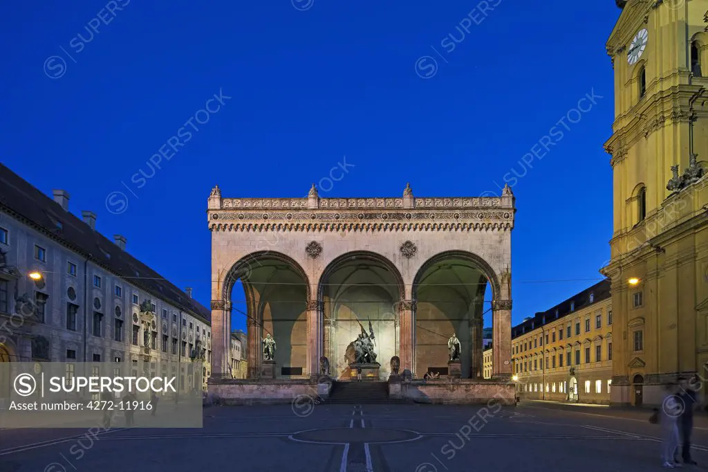 Main Facade of the the Felderrnhalle Monument (Field Marshals Hall) , located at the Odeansplatz in Munich, Bayern, Germany by night.  The Theatinerkirche St. Kajetin is located on the right.