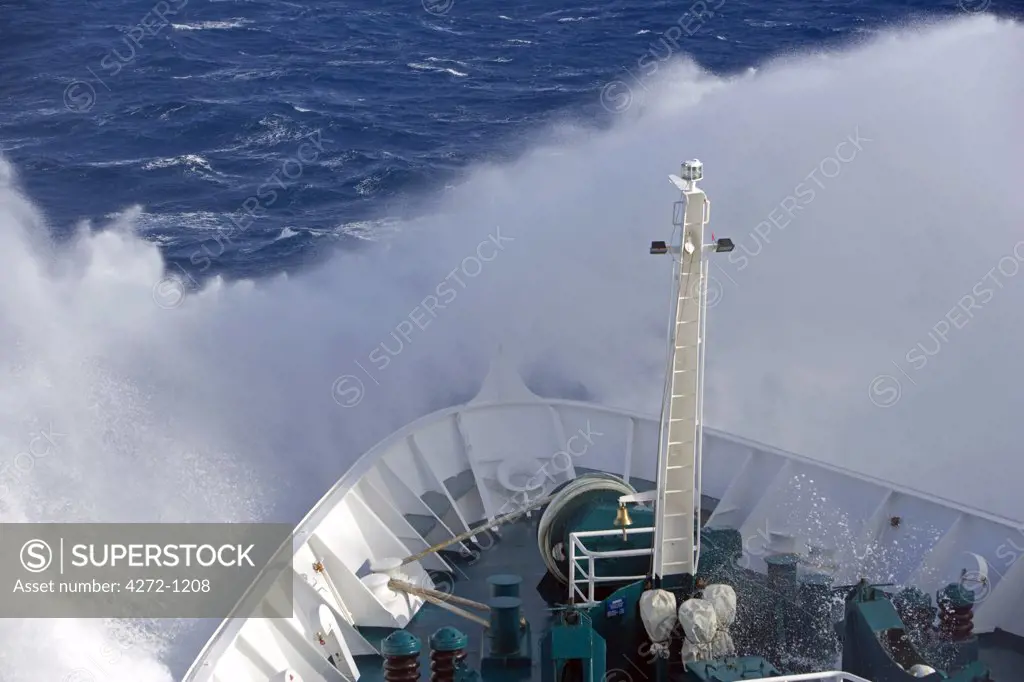Antarctica, Antarctic Peninsula, Drakes Passage. Running into heavy seas, the bow of the expedition ship MV Discovery cut a path through the deep blue sea separating the southern continent from South America.