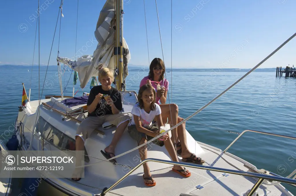 Family eating ice cream on a sailing boat in Hagnau,  Lake Constance, Baden-Wuerttemberg, Germany