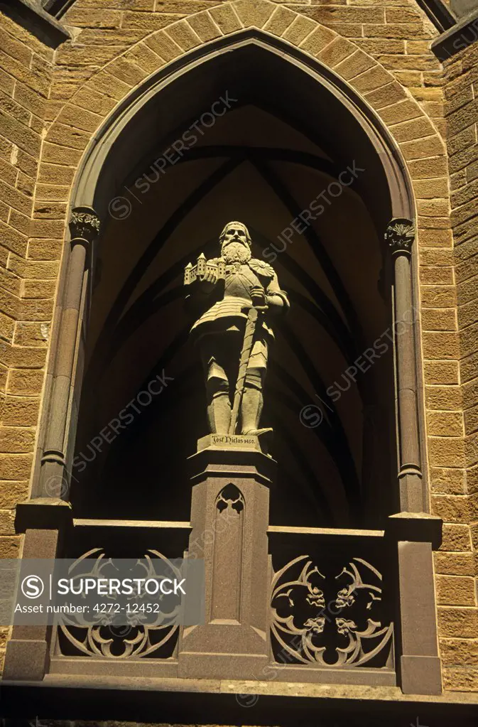 Germany, Baden-Wurttemberg, Swabia, Hechingen. A statue of Count Jost Nicholas von Zollern overlooks the front courtyard of Hohenzollern Castle (he commenced its reconstruction in 1454) situated in the foothills of the Swabian Alps. It was the ancestral seat of the Hohenzollerns who became Germany's emperors. The existing castle was built in the mid-1800s for Frederick William IV of Prussia.