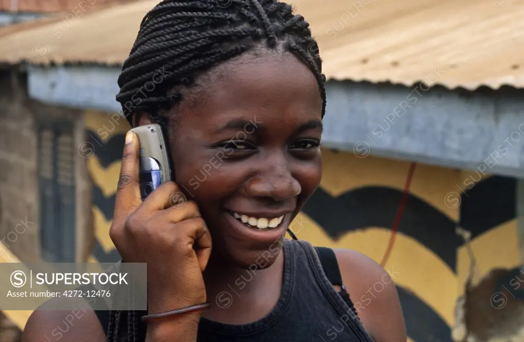 Ghana, Volta Region, Hohoe. Girl on a mobile phone.