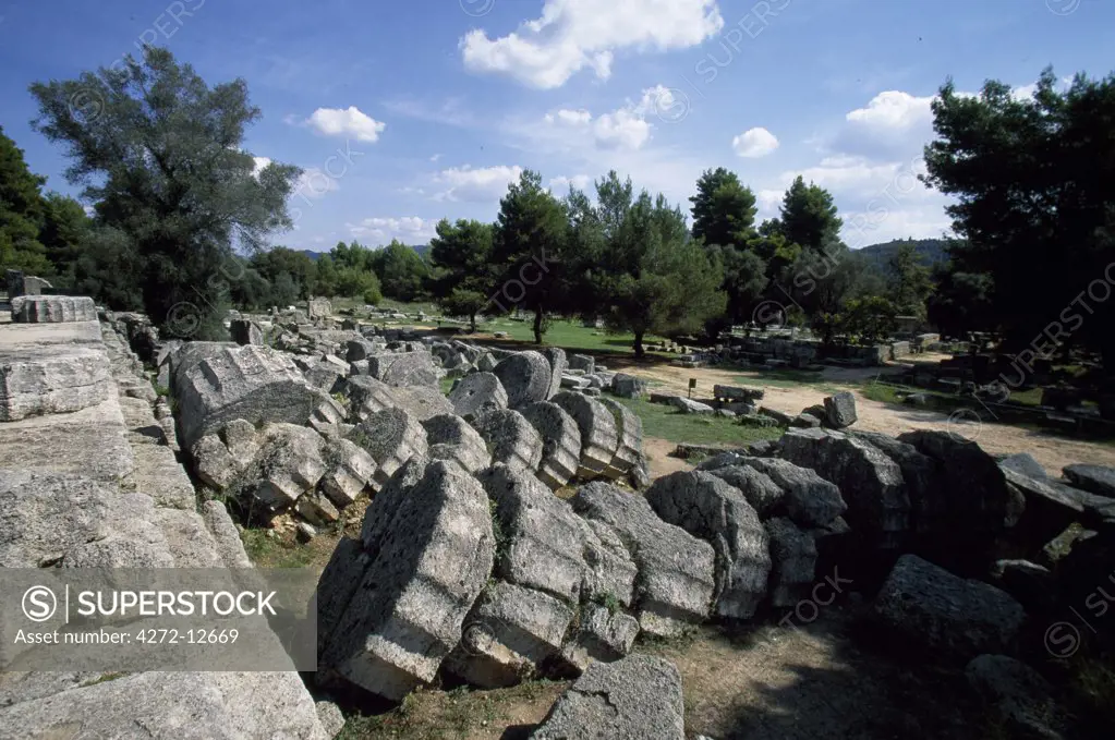 Fallen pillars mark the site of Ancient Olympia's Temple of Zeus, a massive Doric temple constructed in 460BC that housed an enthroned stataue of the god made from wood, ivory and gold. The famous sculptor, Peidias, created the statue and you can still see the remains of his workshop nearby.