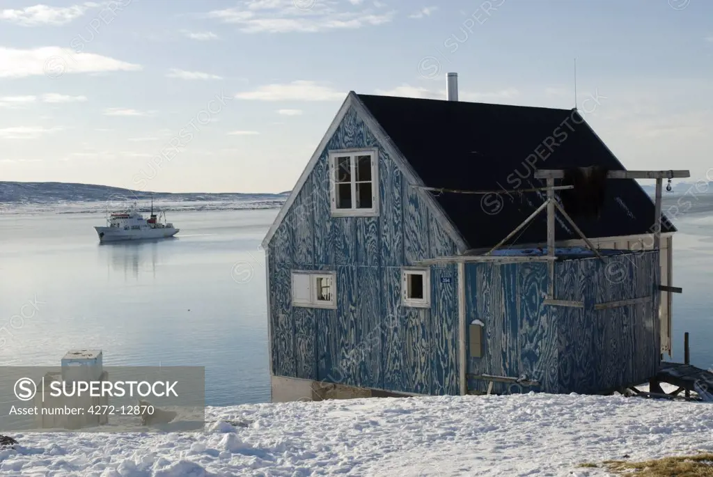 Greenland, Ittoqqortoormiit. The isolated village of Ittoqqortoormiit (Scoresbysund) situated on the north east coast of Greenland. It has 2 food deliveries a year by boat. The Arctic cruise ship Professor Multanovsky, lies anchored in the bay.