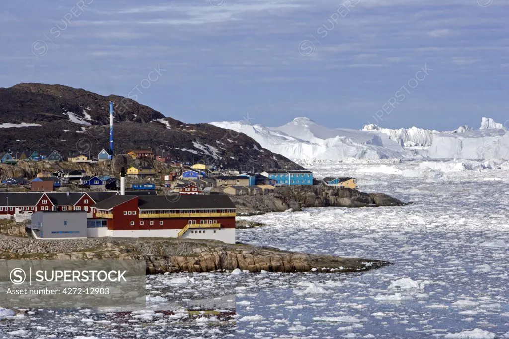 Greenland, Ilulissat, UNESCO World Heritage Site Icefjord.   The entrance to the port area of the town showing scattered bergy bits and large tabular bergs in the background.