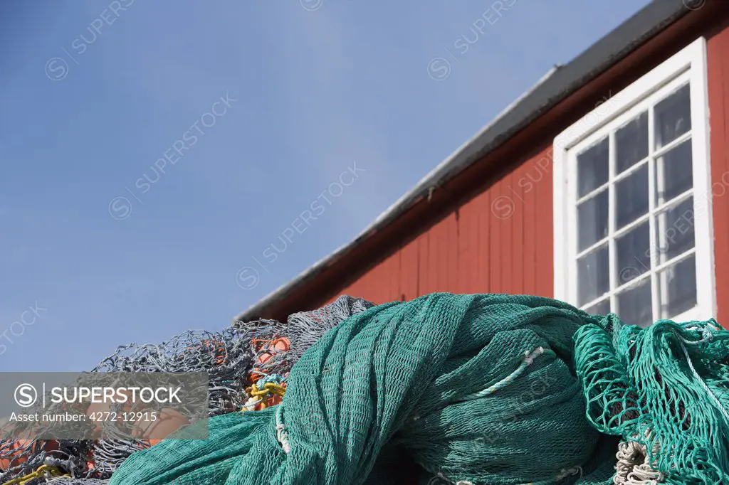 Greenland, Ilulissat.  In the port area, fishing nets await repair outside a traditional house.
