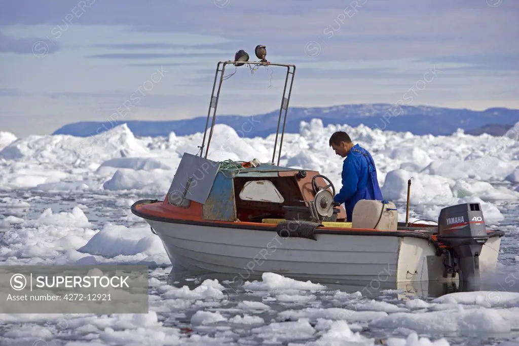Greenland, Ilulissat, UNESCO World Heritage Site Icefjord.   The area is very busy with local small scale fishing activities with boats forced to follow unique passages through the ice.