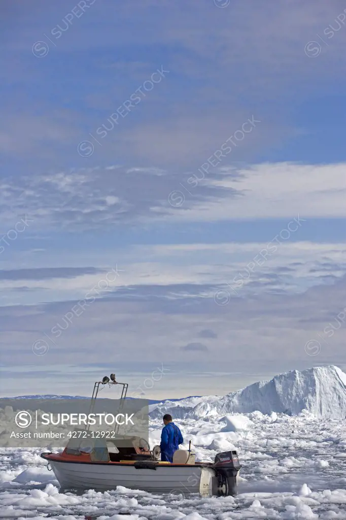 Greenland, Ilulissat, UNESCO World Heritage Site Icefjord.   The area is very busy with local small scale fishing activities with boats forced to follow unique passages through the ice.