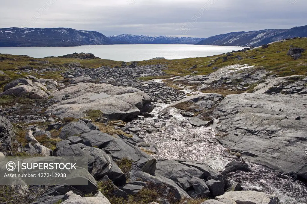 Greenland, Eqi Glacier.   Looking back down towards the glacier and the lagoon to its front from the surrounding mountain.