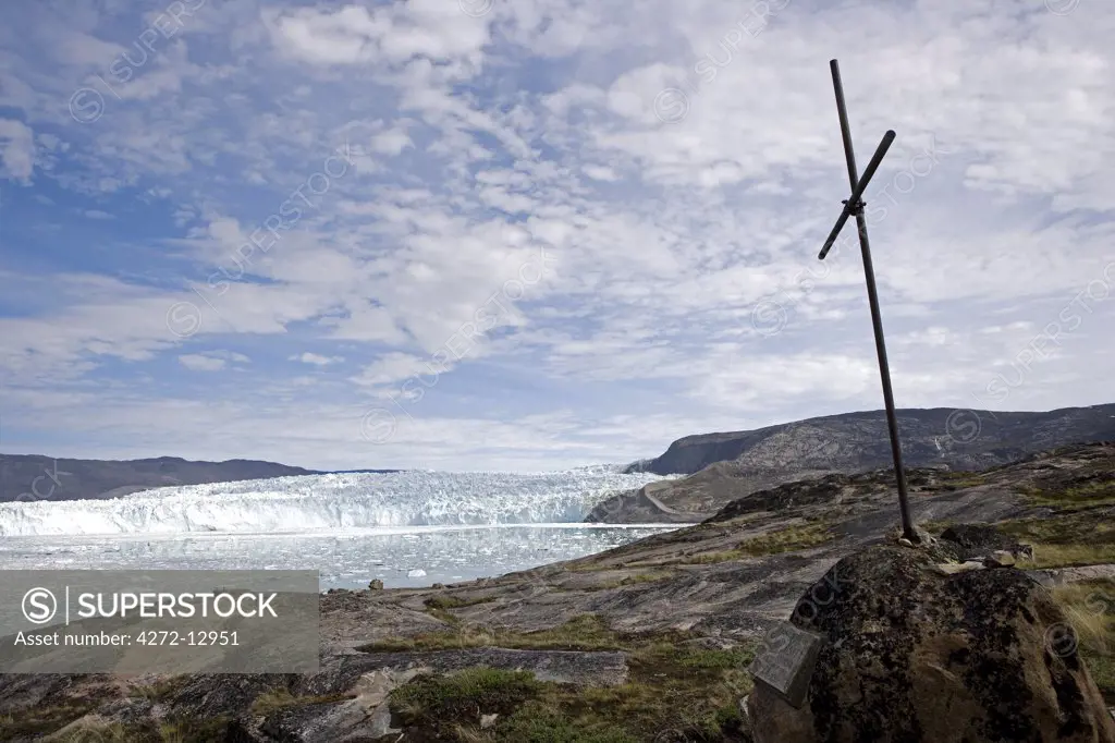 Greenland, Eqi Glacier.   A wooden cross marks the location of Paul-_mile Victors Polar Expedition field base,placed to look across the bay to the front of the active snout of the glacier.