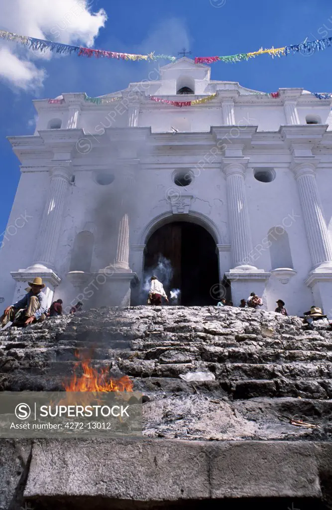 Incense burns at the foot of steps before Santo Tomas Church, reflecting the fusion of Mayan spiritual belief and Catholicism peculiar to Guatemala