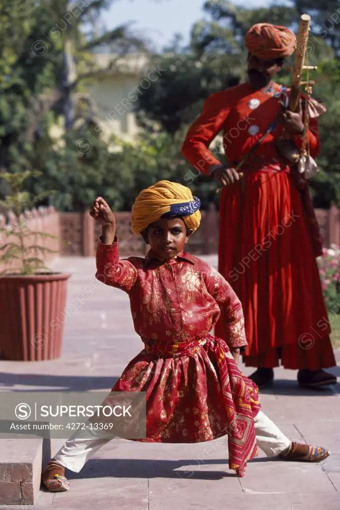 Small boy dancing accompanied by musicians, Jai Mahal Palace Hotel