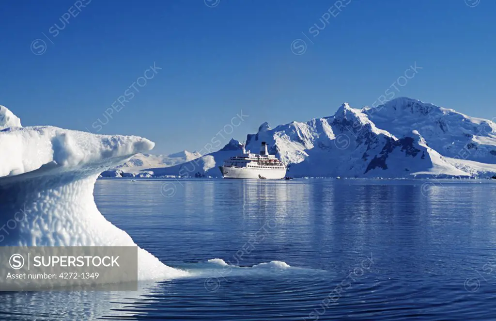 Antarctica, Antarctic Peninsula, Paradise Harbour. MV Discovery in Paradise Harbour with surrounding peaks and icebergs. Antarctic Peninsula.
