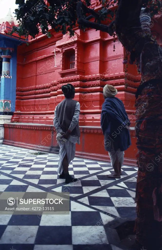 Pilgrims pause in the courtyard of a Hindu temple, one of nearly five hundred that crowd this holy town.