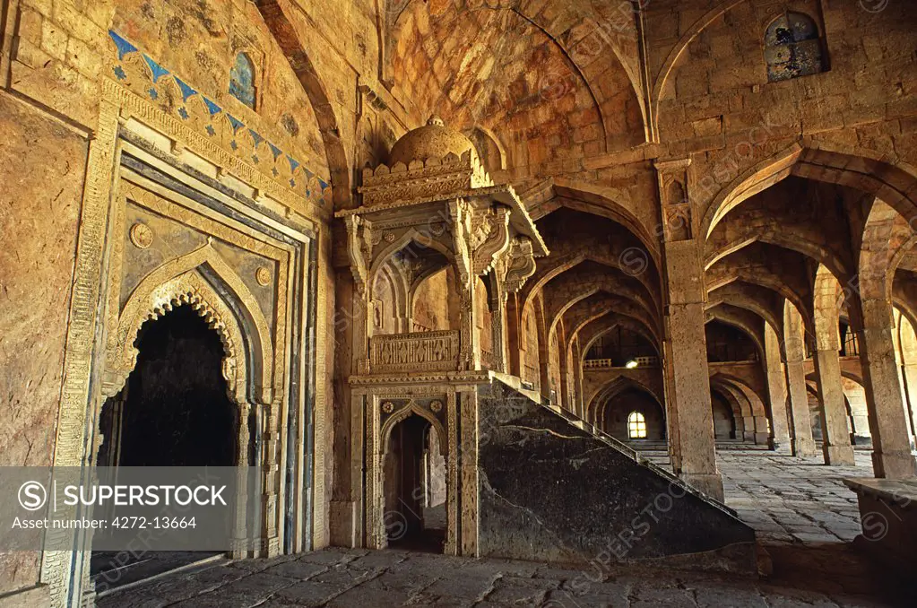 Jami Masjid, one time fortress capital of the Malwa sultans, and later pleasure retreat of the Mughals, Mandu's 15th-century Jami Masjid is its finest remaining building. Numerous arches and pillars support its domed prayer hall. The central niche, shown here beside a raised pulpit, is ornamented with a scroll of Koranic quotations.