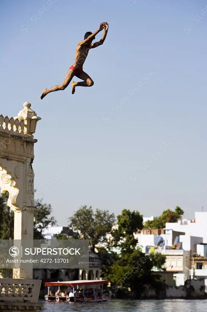 A man jumps into Lake Pichola on a hot day in Udaipur, Rajasthan. India.